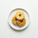 Ananasringe im Milchbackteig gebraten